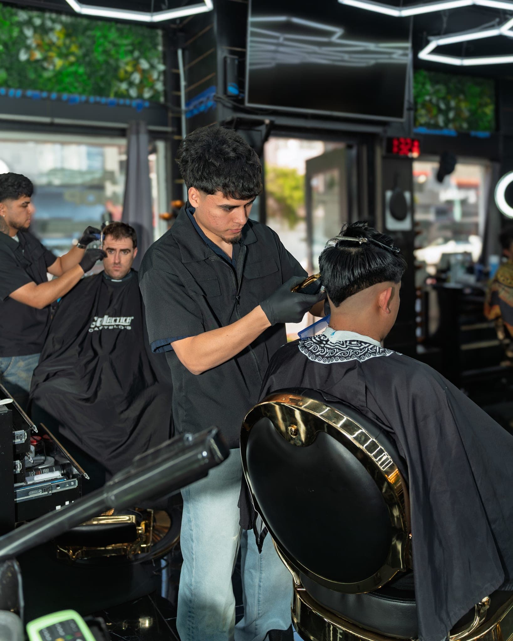 Barber at work at Lion's Den Shave Parlor